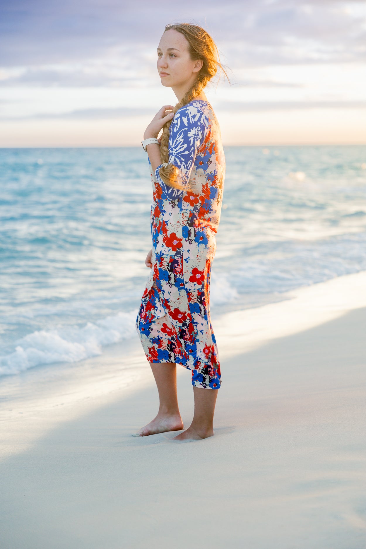 Model wearing Nuggles® Sport Swim Dress in Firecracker Garden