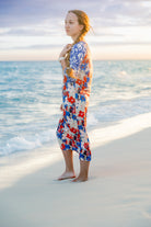 Model wearing Nuggles® Sport Swim Dress in Firecracker Garden