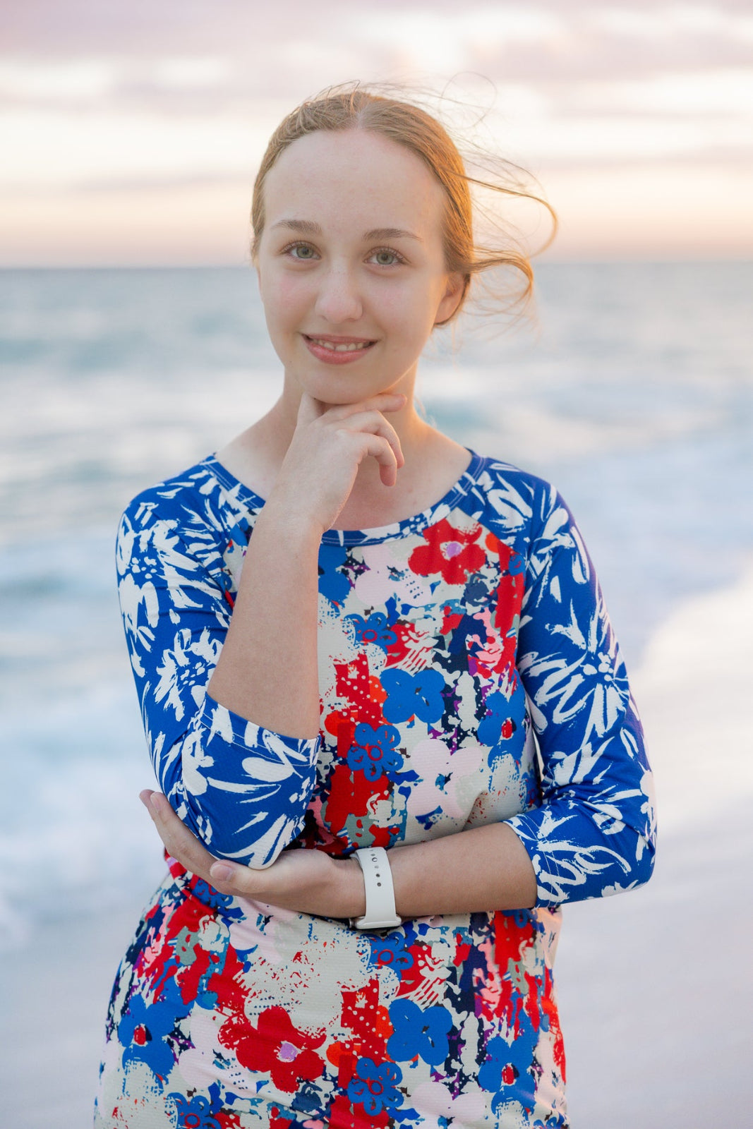 Model wearing Nuggles® Sport Swim Dress in Firecracker Garden