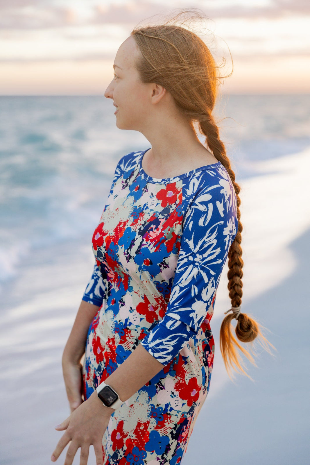 Model wearing Nuggles® Sport Swim Dress in Firecracker Garden