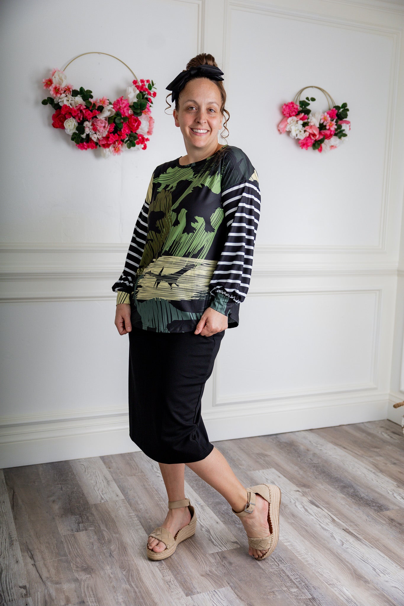 Model wearing the Nuggles® Jaxon Bryauna Top, a long-sleeve modest shirt with dinosaur and stripe print, styled for everyday wear and created as part of a fundraiser in honor of Jaxon.