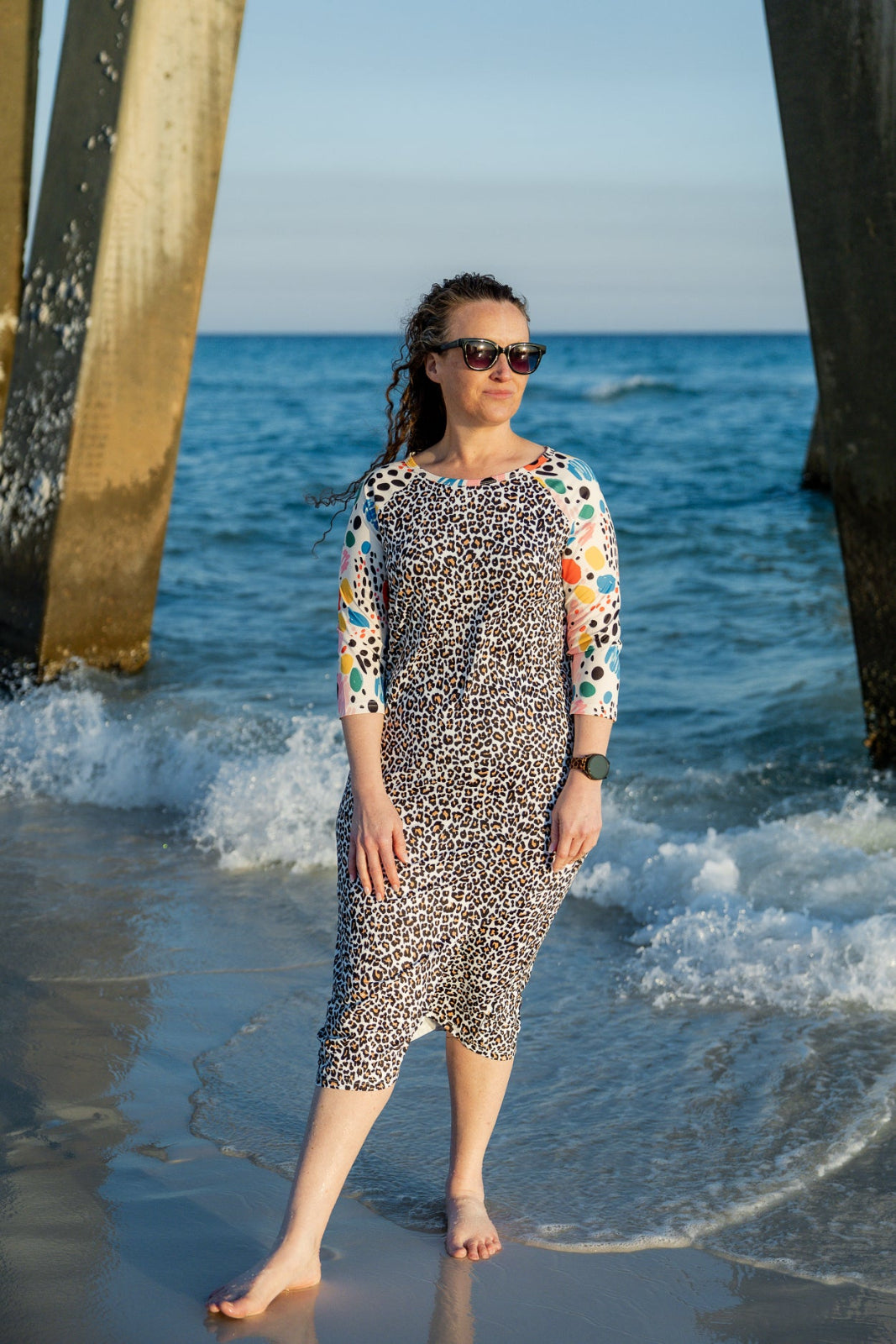 Model wearing Nuggles® Sport Swim Dress in Confetti Leopard