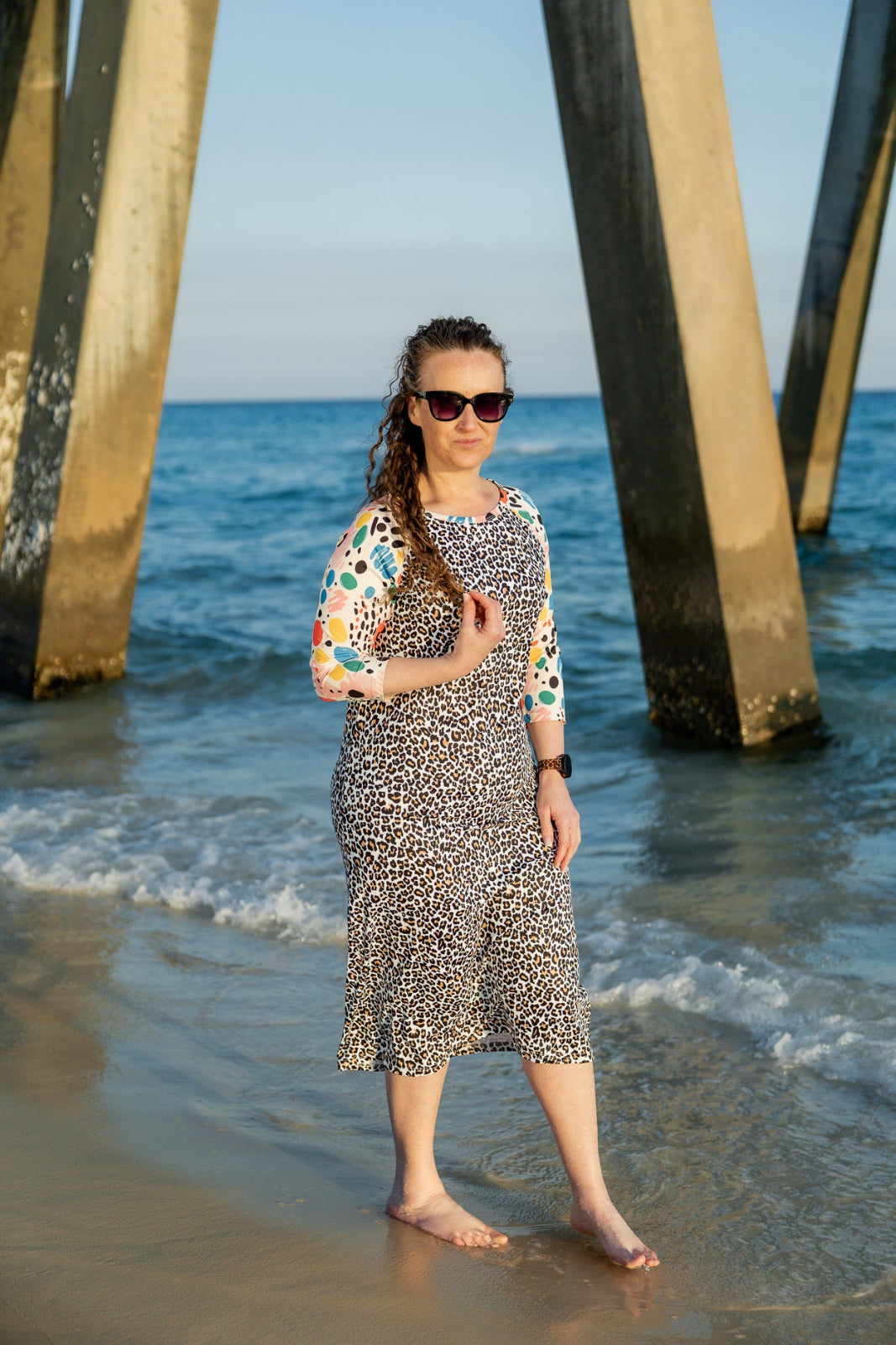 Model wearing Nuggles® Sport Swim Dress in Confetti Leopard