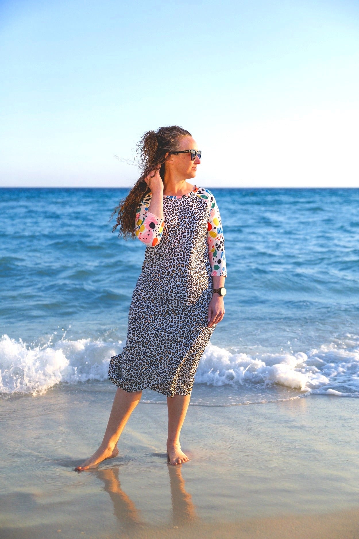 Model wearing Nuggles® Sport Swim Dress in Confetti Leopard