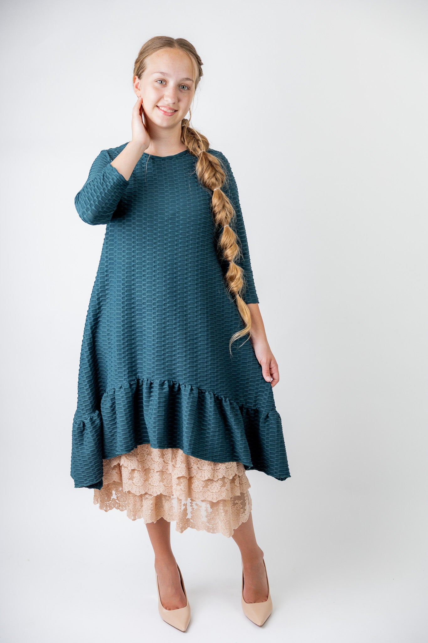 Model wearing 27" lace layering slip with tiered lace hem, designed for modest layering under skirts or dresses.