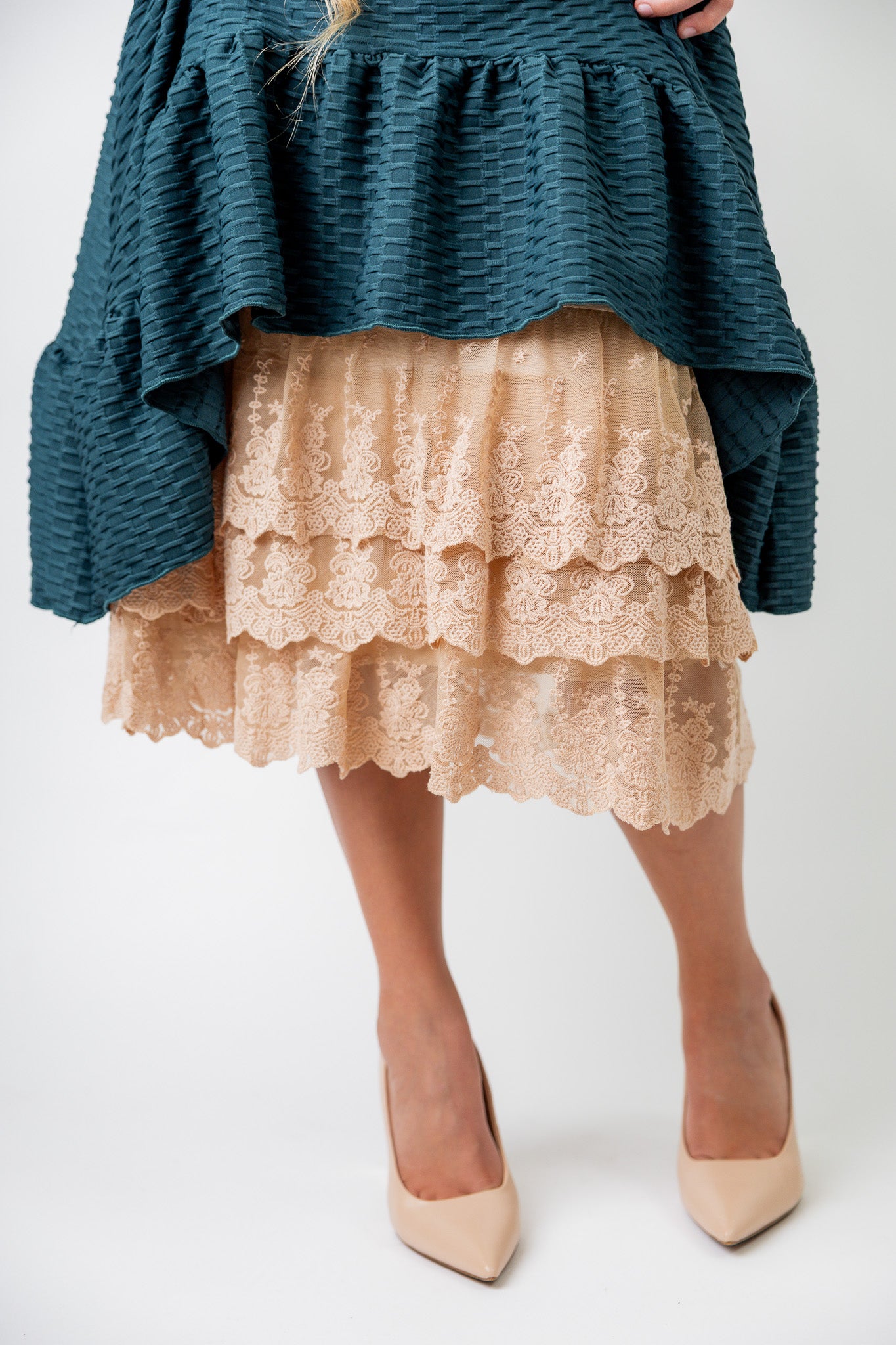 Model wearing 27" lace layering slip with tiered lace hem, designed for modest layering under skirts or dresses.