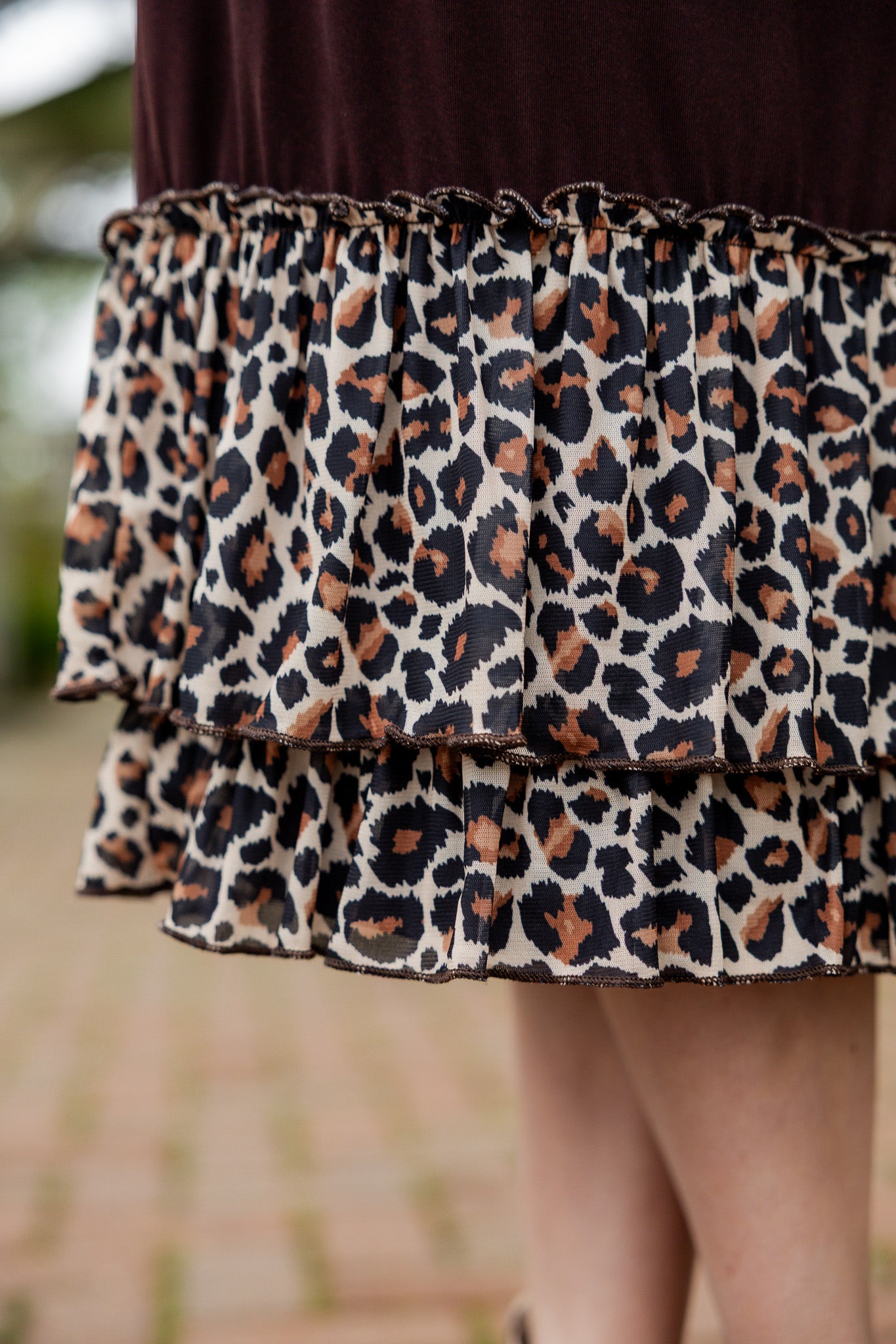 Chocolate brown 27" slip skirt with a layered leopard print ruffle hem, styled for a modest look.