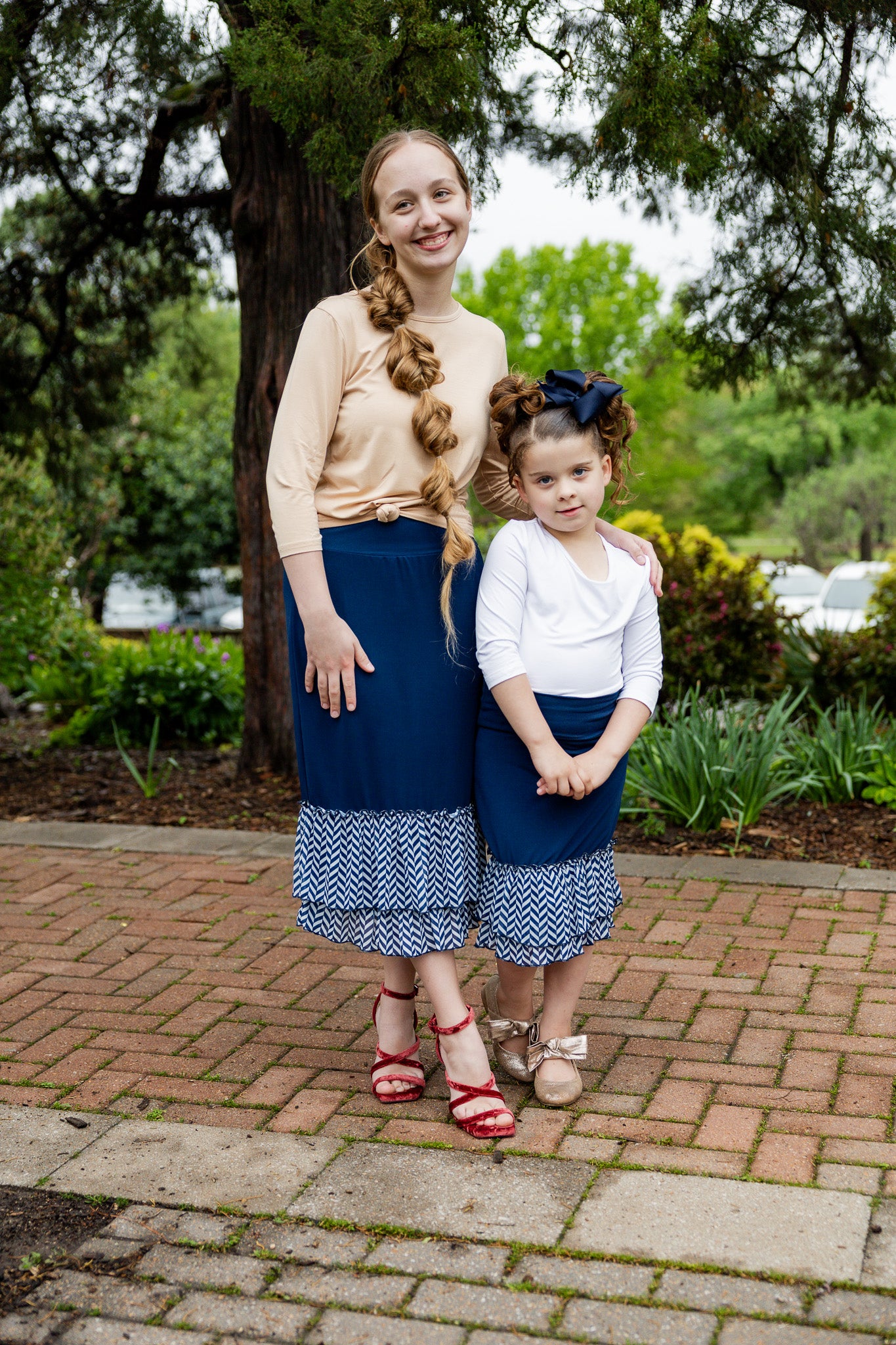 Navy 27" slip skirt with double ruffle hem in white and navy chevron pattern, styled with a beige top.