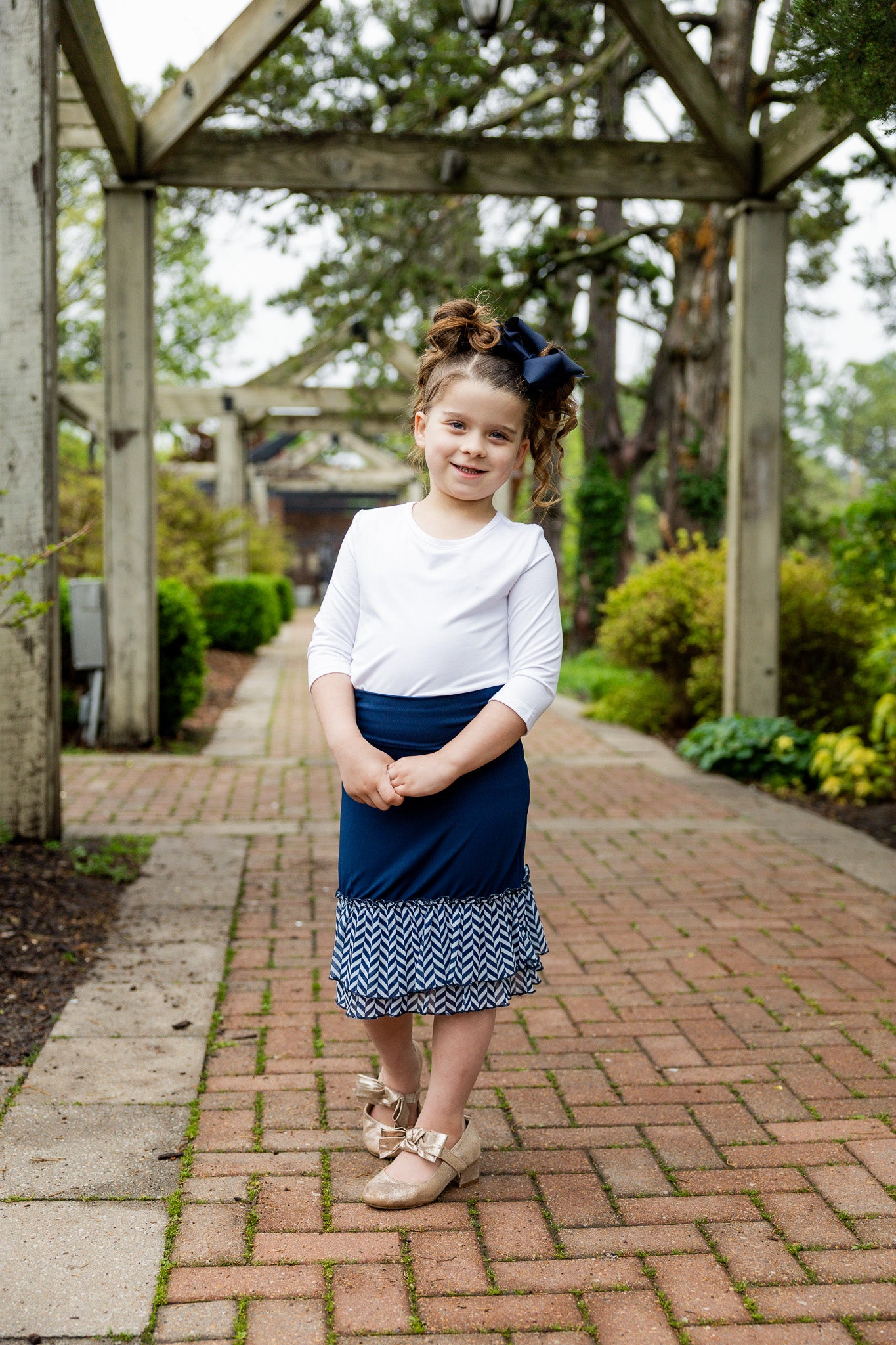 Modest girls’ ruffle slip with wide no-elastic waistband, perfect for layering under dresses and skirts.