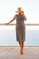 Model wearing Nuggles® Sport Swim Dress in Confetti Leopard