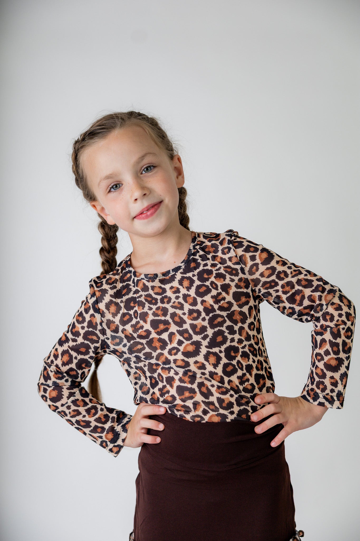 Girl wearing long sleeve mesh layering top by Nuggles® in breathable stretch fabric.