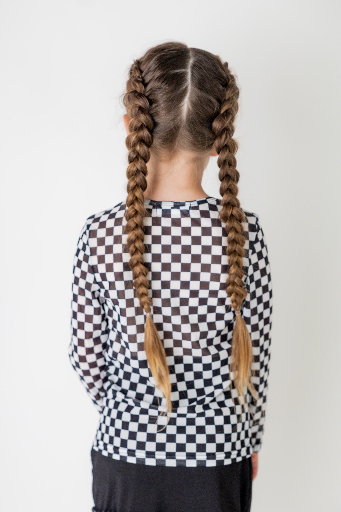 Girl wearing long sleeve mesh layering top by Nuggles® in breathable stretch fabric.