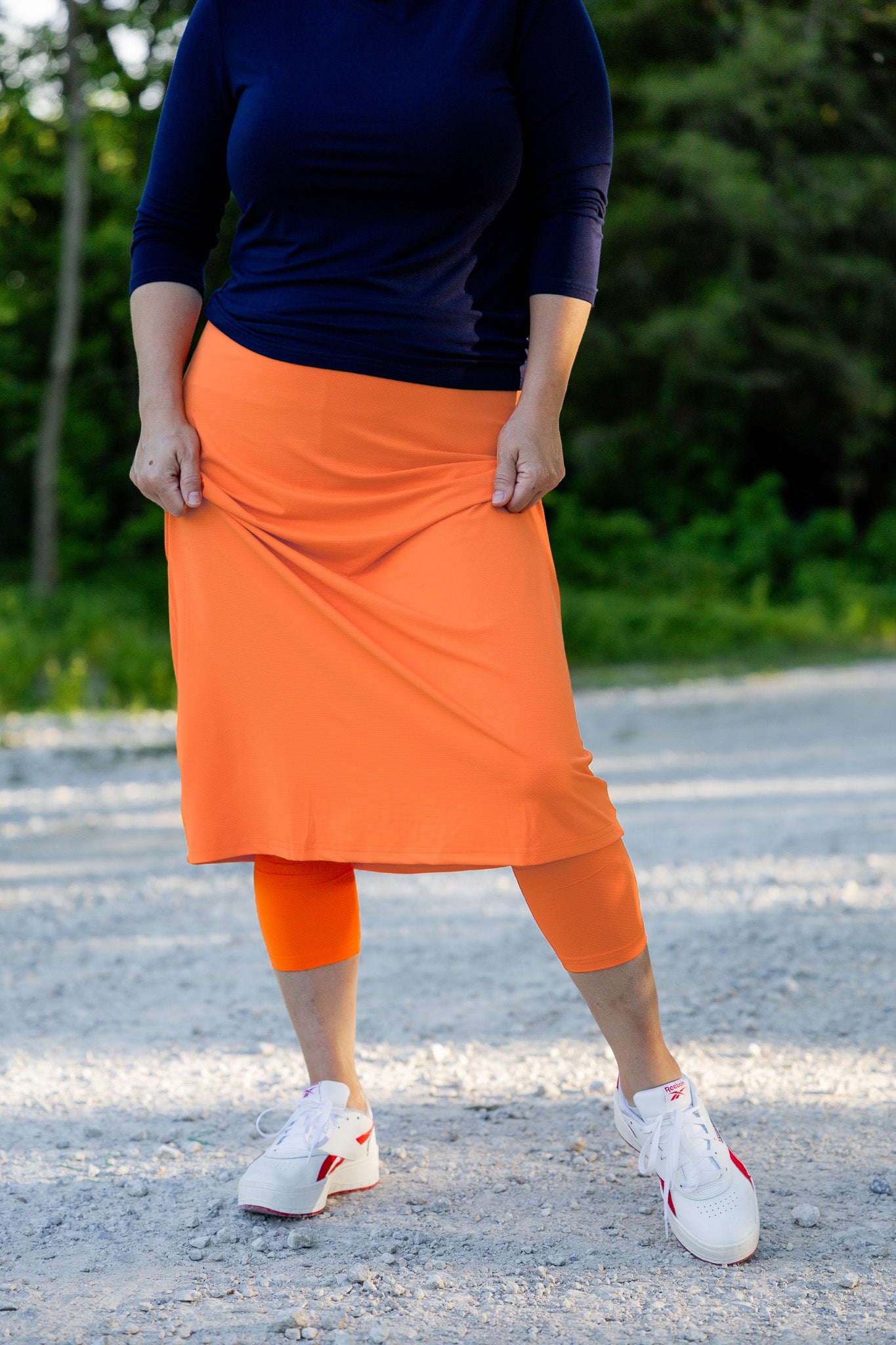 Modest activewear skirt with built-in leggings for women, breathable athletic fabric, paired with sneakers – perfect for workouts or casual wear.