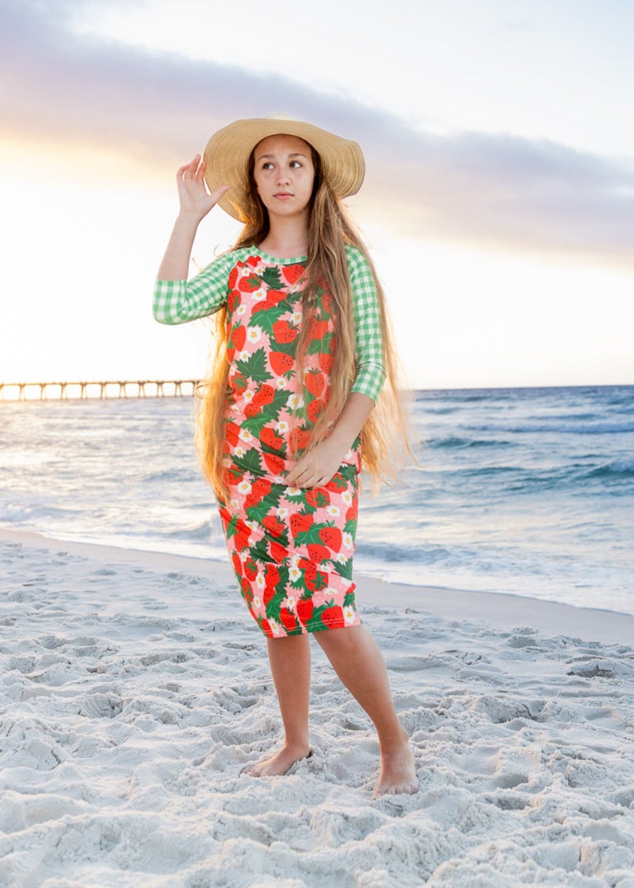 Model wearing Nuggles® Sport Swim Dress in Strawberry Patch