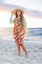 Model wearing Nuggles® Sport Swim Dress in Strawberry Patch