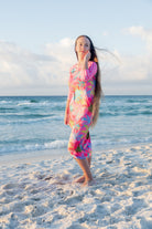 Model wearing Nuggles® Sport Swim Dress in Tropical Daydream