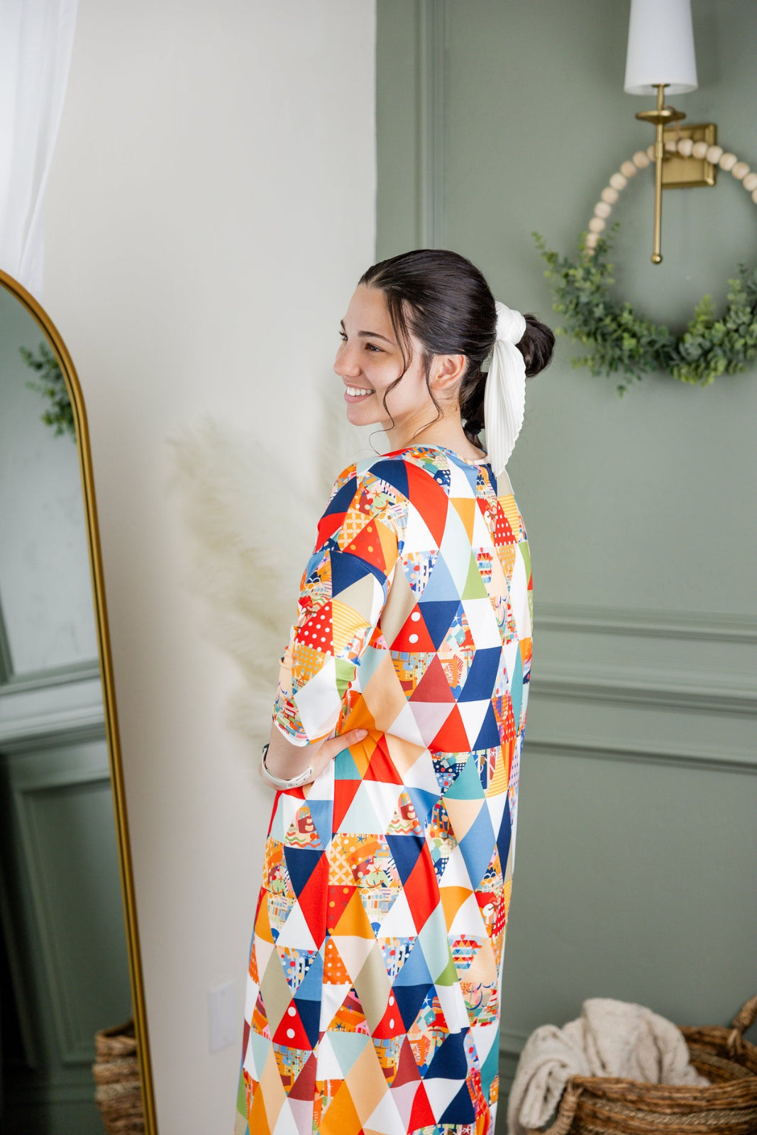 Model wearing Nuggles® Heather Dress in Triangle Taffy 