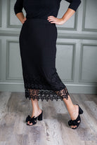 Model wearing Nuggles® lace panel skirt with floral lace hem detail – modest fashion midi skirt.