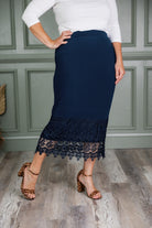 Model wearing Nuggles® lace panel skirt with floral lace hem detail – modest fashion midi skirt.