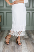 Model wearing Nuggles® lace panel skirt with floral lace hem detail – modest fashion midi skirt.
