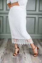 Model wearing Nuggles® lace panel skirt with floral lace hem detail – modest fashion midi skirt.