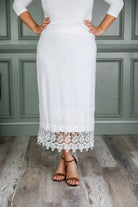 Model wearing Nuggles® lace panel skirt with floral lace hem detail – modest fashion midi skirt.