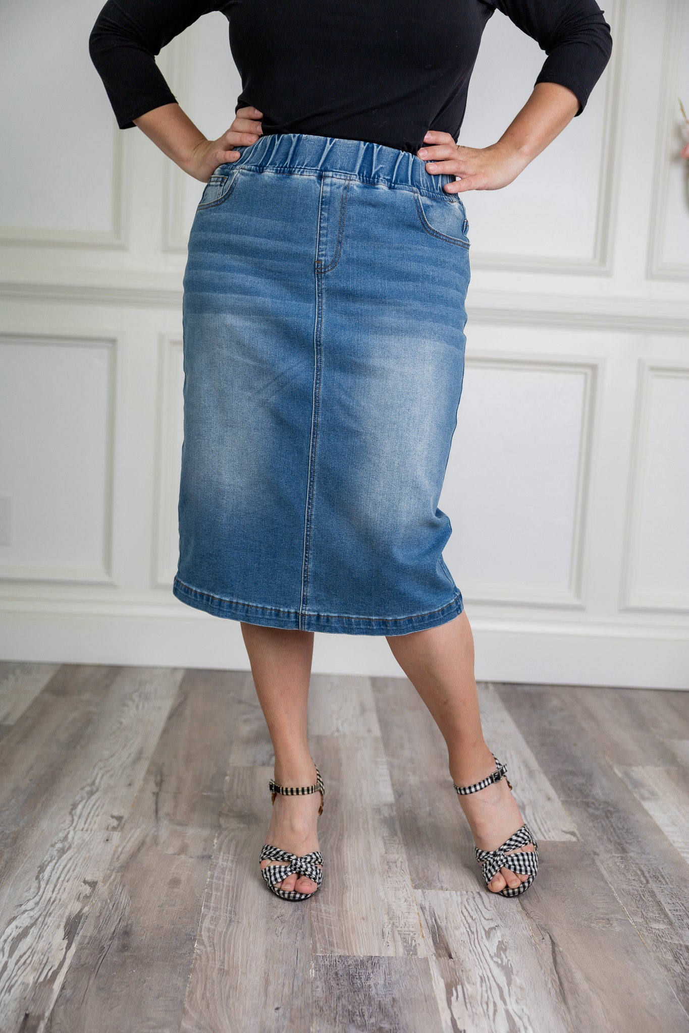 Nuggles denim midi skirt with soft stretch fabric, wide elastic waistband, modest length, and functional pockets. Available in 27", 31", and 34" lengths.