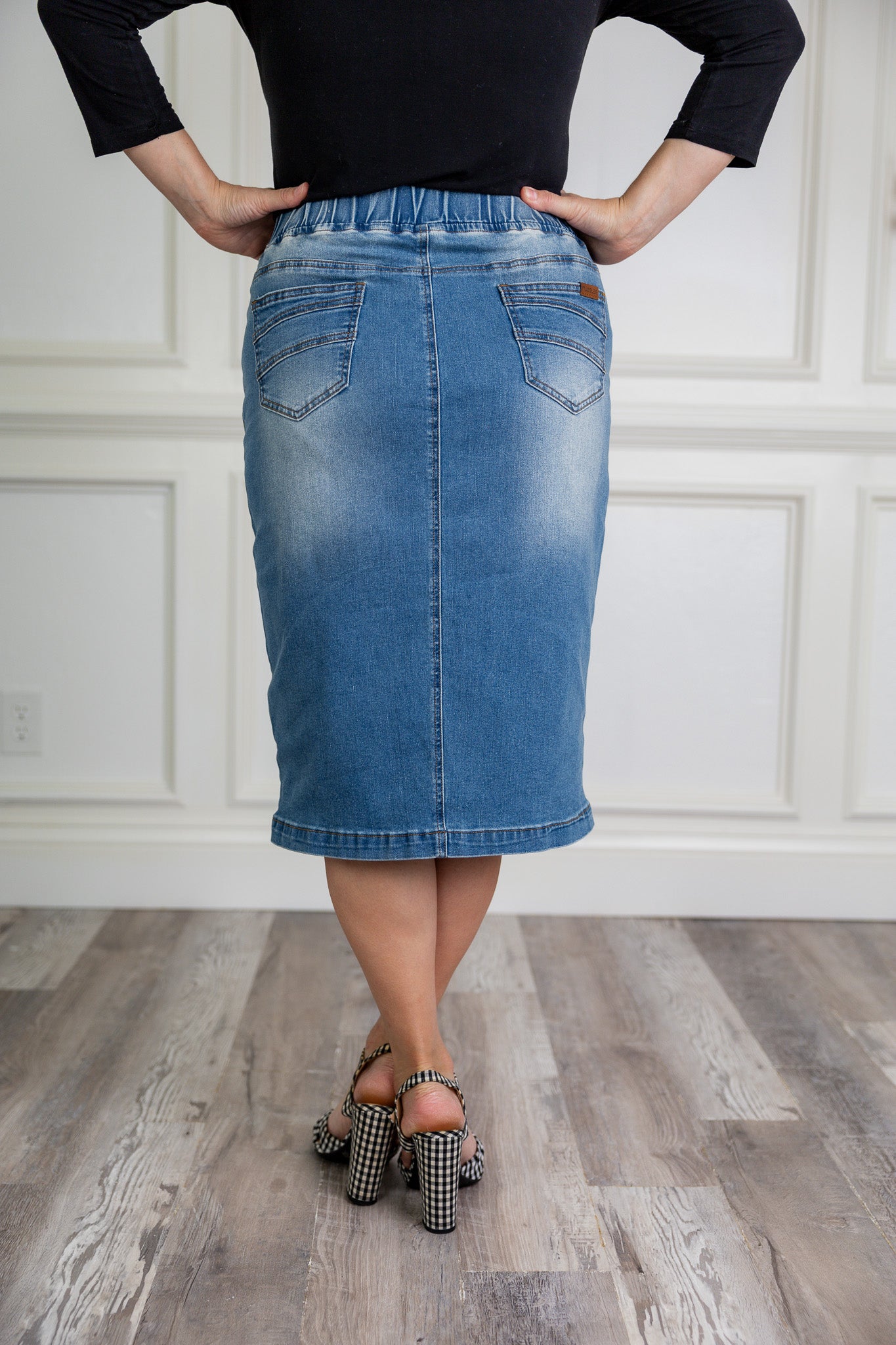 Nuggles® denim midi skirt with soft stretch fabric, wide elastic waistband, modest length, and functional pockets. Available in 27", 31", and 34" lengths.