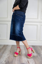 Nuggles denim midi skirt with soft stretch fabric, wide elastic waistband, modest length, and functional pockets. Available in 27", 31", and 34" lengths.