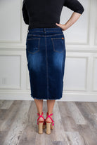 Nuggles denim midi skirt with soft stretch fabric, wide elastic waistband, modest length, and functional pockets. Available in 27", 31", and 34" lengths.
