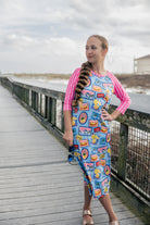 Model wearing Nuggles® Sport Swim Dress in Vacation Postcards