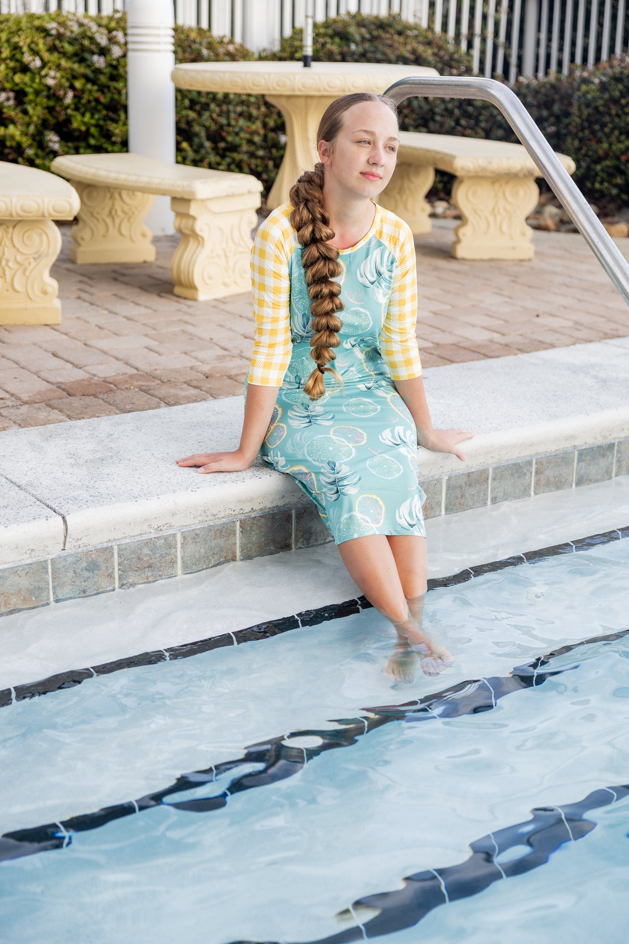 Model wearing Nuggles® Sport Swim Dress in Mint Lemonade