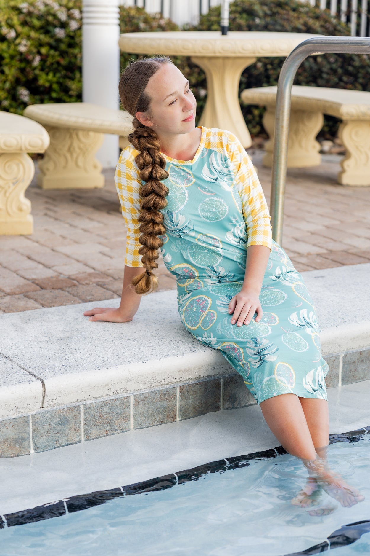 Model wearing Nuggles® Sport Swim Dress in Mint Lemonade