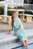 Model wearing Nuggles® Sport Swim Dress in Mint Lemonade