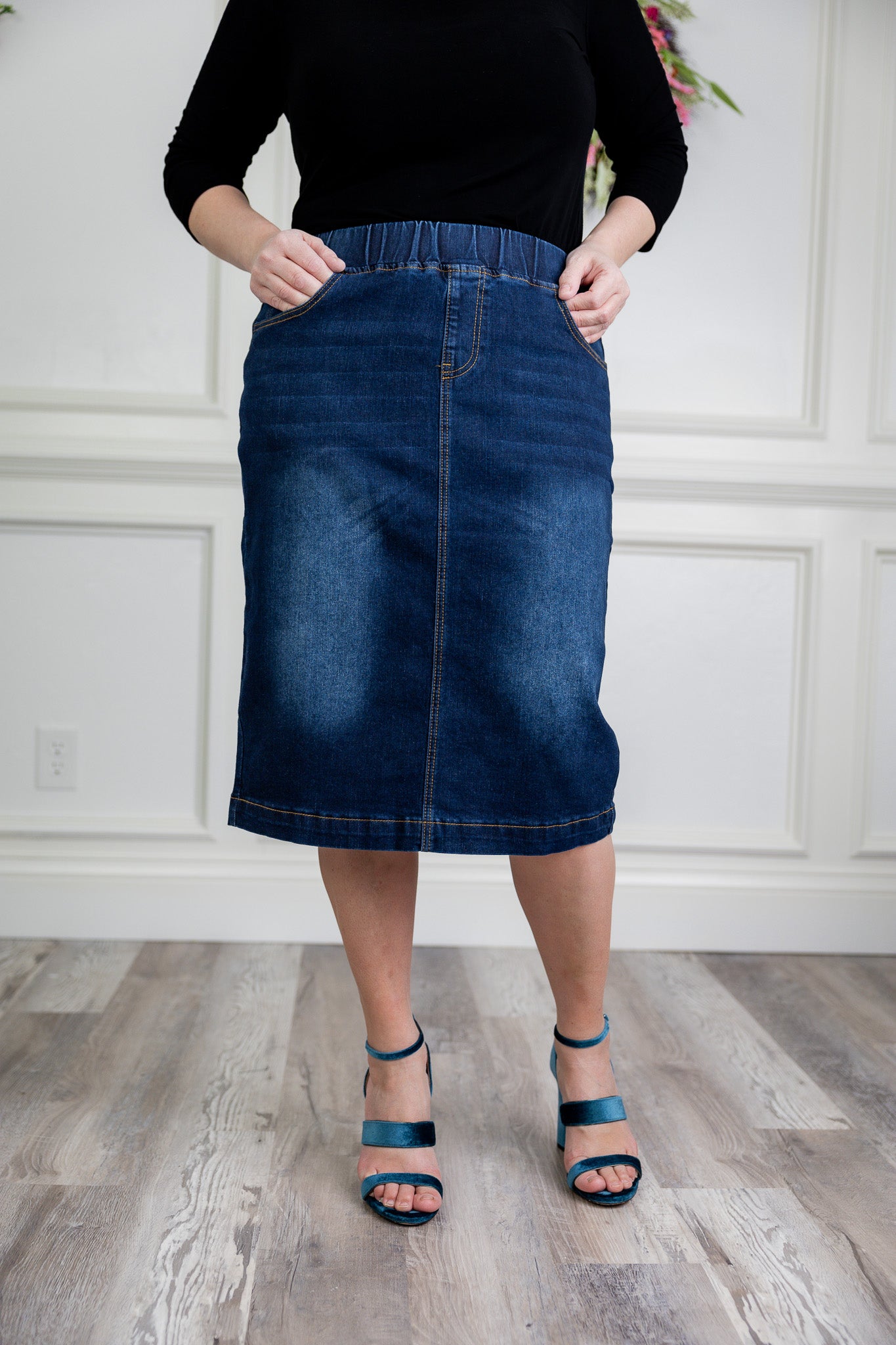 Nuggles denim midi skirt with soft stretch fabric, wide elastic waistband, modest length, and functional pockets. Available in 27", 31", and 34" lengths.