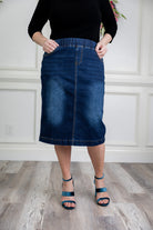 Nuggles denim midi skirt with soft stretch fabric, wide elastic waistband, modest length, and functional pockets. Available in 27", 31", and 34" lengths.