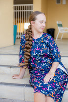 Model wearing Nuggles® Carlie Swim Dress in Nautical Nights