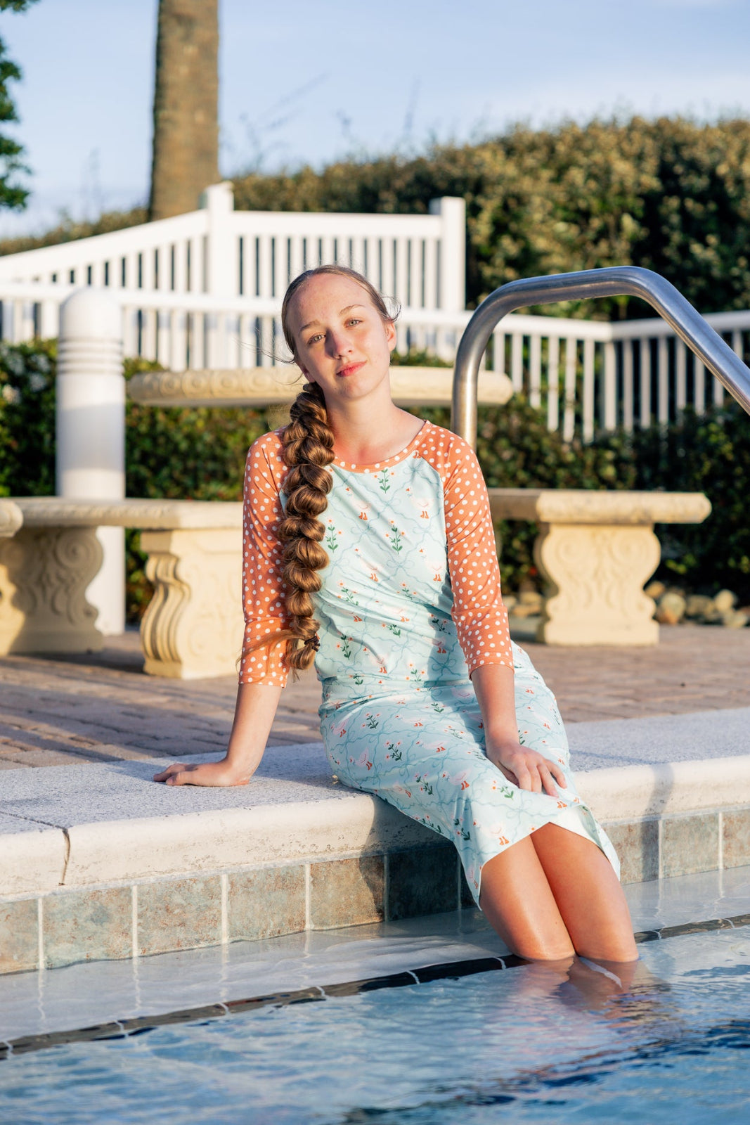 Model wearing Nuggles® Sport Swim Dress in Duckling Garden
