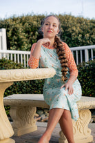 Model wearing Nuggles® Sport Swim Dress in Duckling Garden