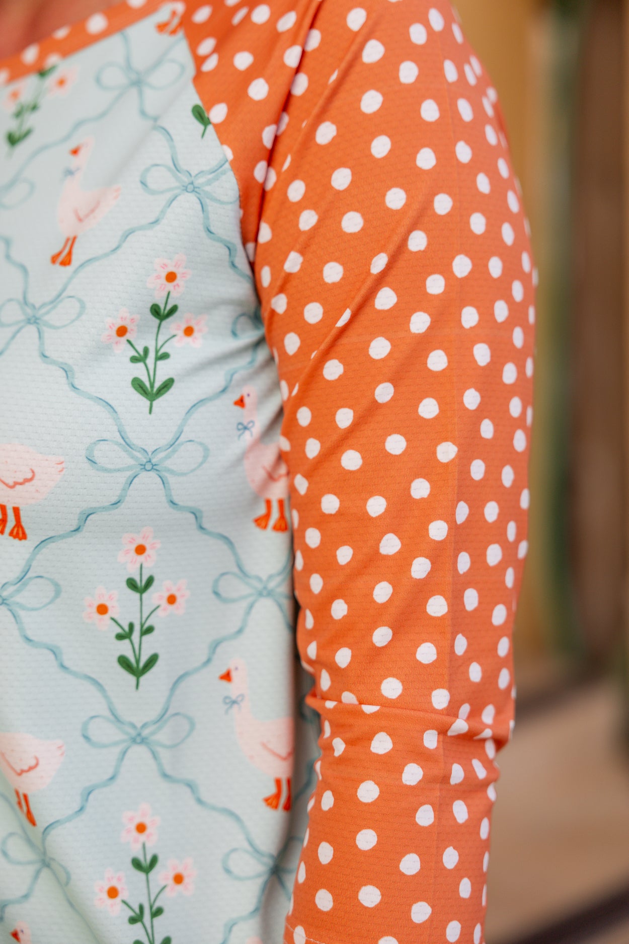 Model wearing Nuggles® Sport Swim Dress in Duckling Garden