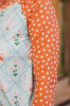 Model wearing Nuggles® Sport Swim Dress in Duckling Garden