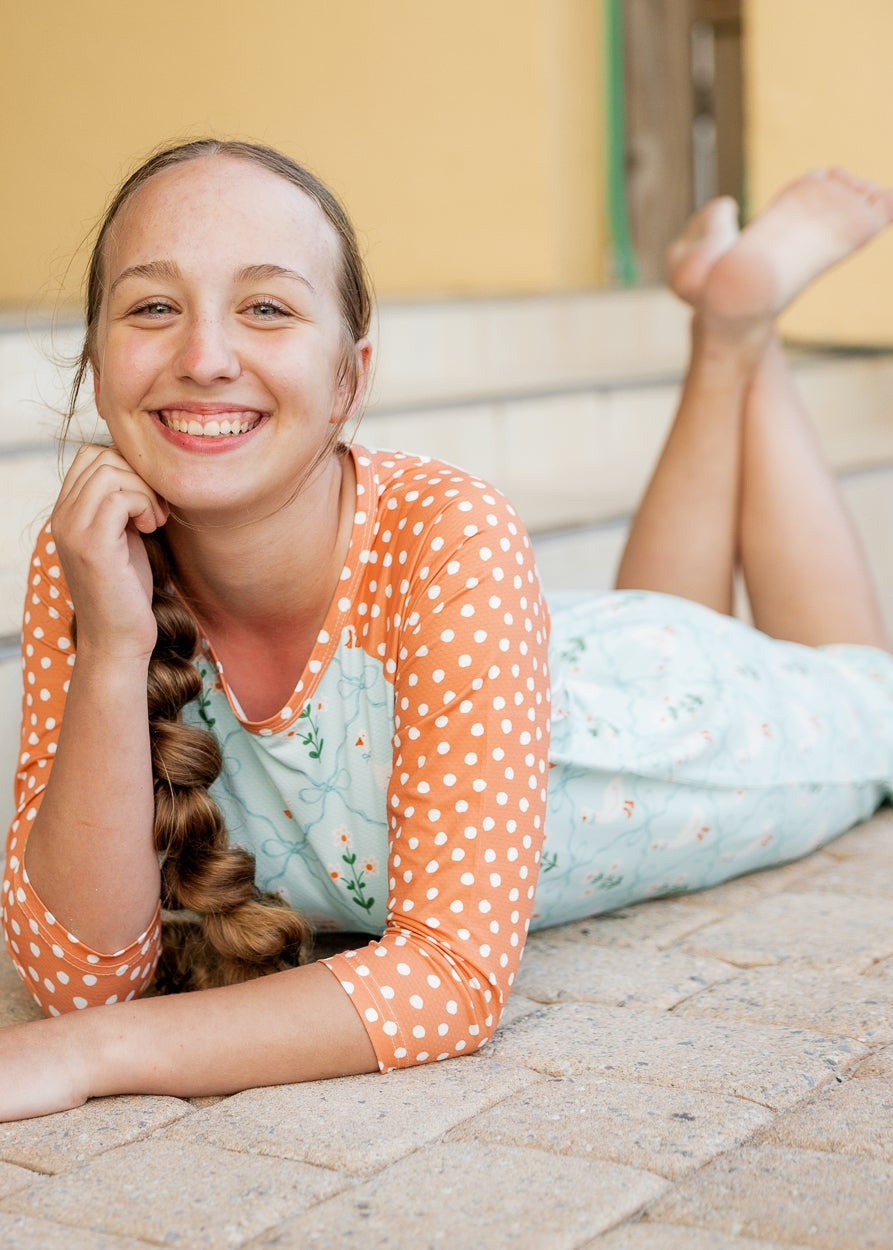 Model wearing Nuggles® Sport Swim Dress in Duckling Garden