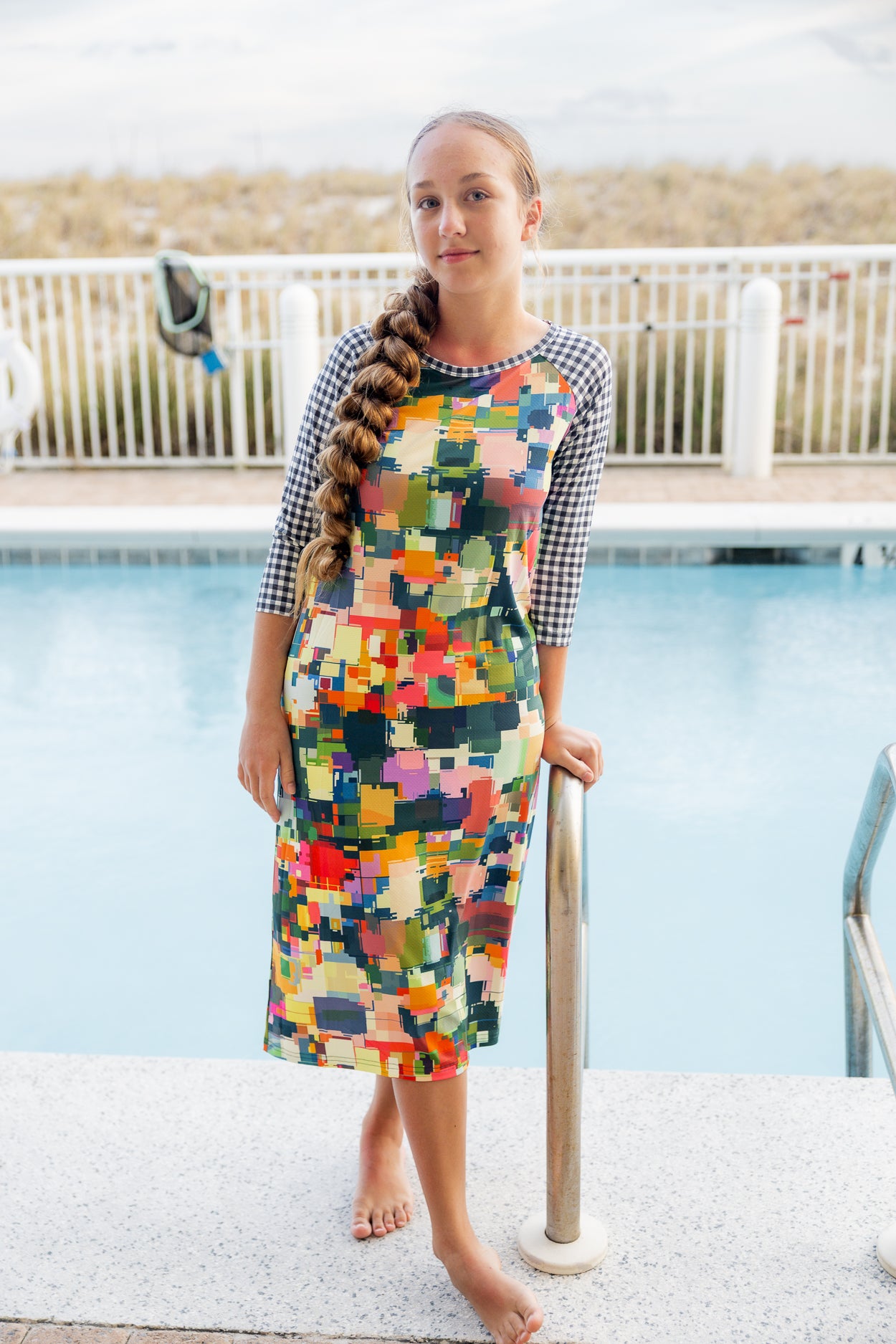 Model wearing Nuggles® Sport Swim Dress in Painted Patchwork
