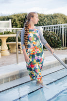 Model wearing Nuggles® Sport Swim Dress in Painted Patchwork