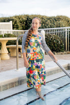 Model wearing Nuggles® Sport Swim Dress in Painted Patchwork