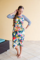 Model wearing Nuggles® Sport Swim Dress in Painted Patchwork