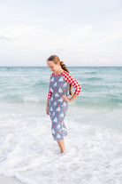 Model wearing Nuggles® Sport Swim Dress in Happy Campers