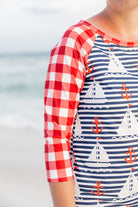 Model wearing Nuggles® Sport Swim Dress in Happy Campers