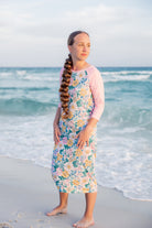 Model wearing Nuggles® Sport Swim Dress in Daisy Daydream
