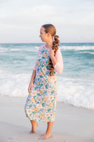 Model wearing Nuggles® Sport Swim Dress in Daisy Daydream